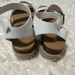Soda white sandals. Not exact sure on size but fits a size 7 foot.